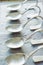 Vertical shot of row of silver bent spoons on the table
