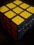 Vertical shot of Rubik\'s cube isolated on a black background