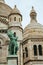 Vertical shot of Sacre Coeur basilica with the Jeanne d\'Arc statue in Paris, Montmartre, France