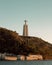Vertical shot of a Sanctuary of Christ the King monument on the hill in Lisbon, Portugal