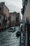 Vertical shot of scenery of boats sailing in the canals of historic Venice