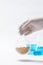 Vertical shot of a scientist holding chickpeas in a flask against a white background