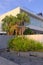 Vertical shot of the seaside Villa with Palms on a sunny day