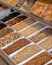 Vertical shot of a selection of dried nuts displayed on a market stall