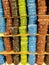 Vertical shot of several spools of colorful thread on the shelf