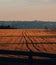 Vertical shot of shadows and trails in a field with wheat