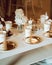 Vertical shot of shiny bronze plates and plastic cups on a white table at abirthday party