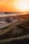 Vertical shot of ships sailing on the sea during sunset in Zoutland, The Netherlands