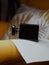 Vertical shot of a sideway a black aesthetic perfume bottle on yellow furniture