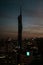 Vertical shot of the silhouette of Warisan Merdeka Tower in Kuala Lumpur during the sunset