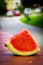 Vertical shot of a slice of watermelon on a wooden surface