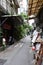 Vertical shot of a small alley between residential buildings with traders in Taipei, Taiwan