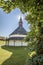 Vertical shot of a small church behind the trees in the countryside Slovenia