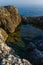 Vertical shot of a small lake formed inside the rocks at the Kamenjak coast in Istria, Croatia