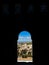 Vertical shot of a small window overlooking the cityscape of Granada, Andalusia Spain