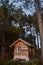 Vertical shot of a small wooden cottage in the woods