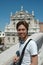 Vertical shot of a smiling male standing near Santa Maria di Nazareth Church in Venice, Italy