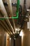 Vertical shot of some metal pipes on a ceiling of a basement corridor