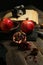 Vertical shot of some pomegranates near an old camera on a wooden table