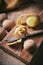 Vertical shot of some potatoes on a wooden board