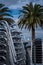 Vertical shot of a stack of chairs with palm trees in the background