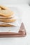 Vertical shot of a stack of homemade cookies with white napkins on a tray