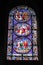 Vertical shot of stained glass with biblical characters on it