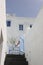 Vertical shot of a staircase among the old traditional white buildings of Santorini Island