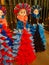 Vertical shot of standing dolls with colorful dresses.