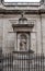 Vertical shot of a statue of John Henry Cardinal Newman outside the Brompton Oratory in London, UK