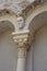 Vertical shot of a stone face on a column with two vaults of an old abbey architecture