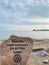 Vertical shot of a stone with a writing on the beach of Ontario lake in Toronto, Canada