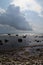 Vertical shot of a stony shoreline under big clouds in Arnager, Bornholm