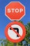 Vertical shot of stop no entry and no left turn road signs in the street