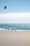 Vertical shot of the sunny Playa del Guincho with people parachuting in the sea, Portugal