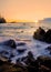 Vertical shot of a sunrise on the coast of Cala dels Canyers in Spain