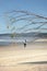 Vertical shot of a surfer walking on Cape Byron beach in Australia