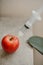 Vertical shot of a syringe injected into an apple