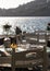 Vertical shot of tables and chairs at a Greek taverna on the island of Ios.