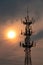 Vertical shot of a tall cell tower with a vibrant sunset sky in the background in Deyang, China