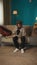 Vertical shot of a teenager, young man sitting on a sofa, couch, reading a document, paper, admission, waiting to see