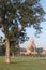 Vertical shot of a temple building in Khajuraho, India surrounded by green trees under the blue sky