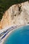 Vertical shot of the tents and the turquoise water of the Porto Katsiki Beach in Lefkada, Greece