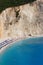 Vertical shot of the tents and the turquoise water of the Porto Katsiki Beach in Lefkada, Greece