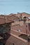 Vertical shot of the tile rooftops of the stone old houses by the lake