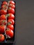 Vertical shot of tomatoes on wood - ecologic concept