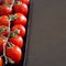 Vertical shot of tomatoes on wood - ecologic concept