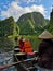 Vertical shot of the tourists traveling in boats in Ninh Binh, Viet