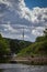 Vertical shot of a tower building against fluffy white clouds