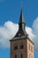 Vertical shot of the tower of Roman Catholic bishopric of Odense against blue sky, Denmark